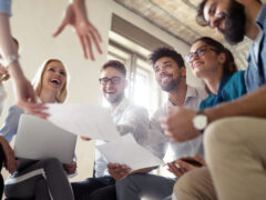 A group of students are laughing and working together