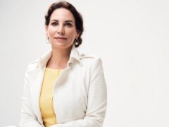 Portrait of Katrin Winkler with brown hair and a white jacket