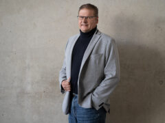A portrait of Prof. Dr. Michael Lenke wearing glasses. He smiles.